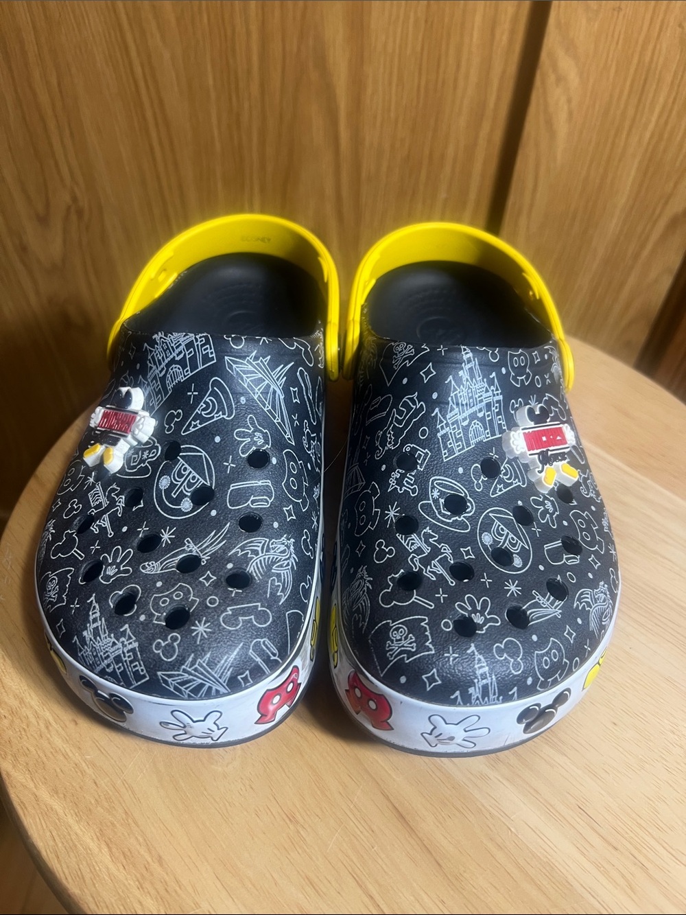 CROCS Kids Black Clogs with Yellow Heel Straps and White Doodle Prints